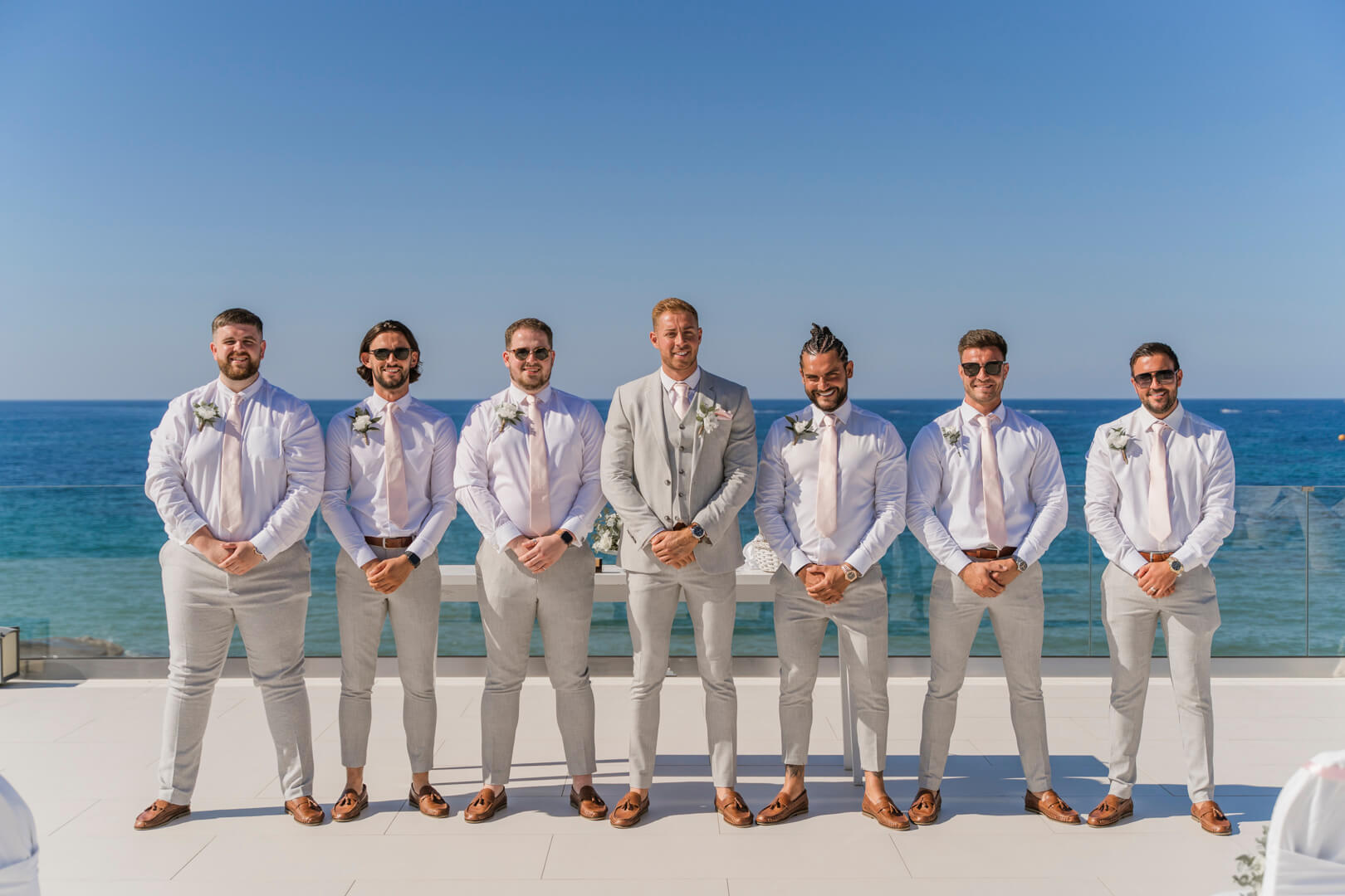 groom and groomsmen in Luxme White Palace wedding venue with sea view
