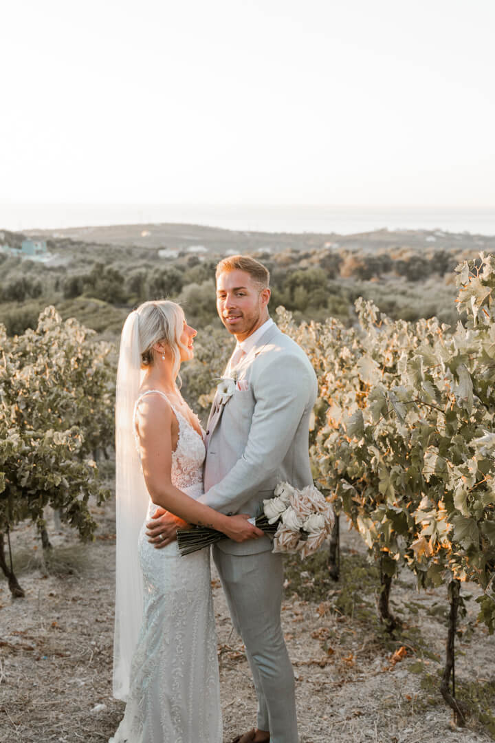 bride and groom in vineyards in Agreco Farms wedding venue in Crete